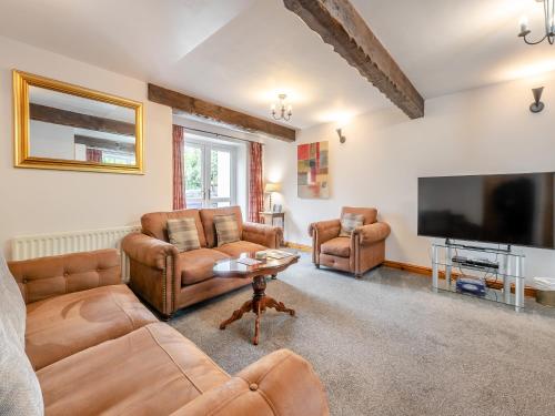 a living room with couches and a flat screen tv at Big Barn - 16439 in York