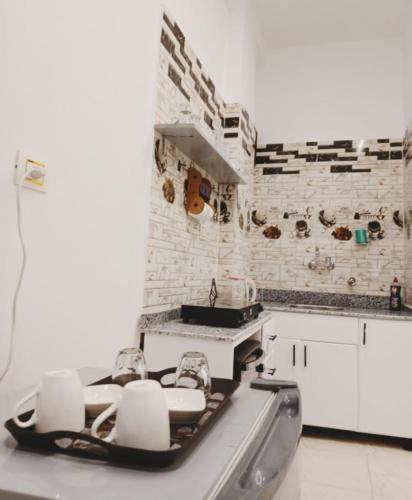 a white kitchen with a sink and a stove at NOOR SEEN House in Luxor