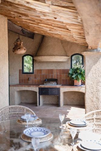 a kitchen with a table with plates on it at Villa le repaire in Ramatuelle