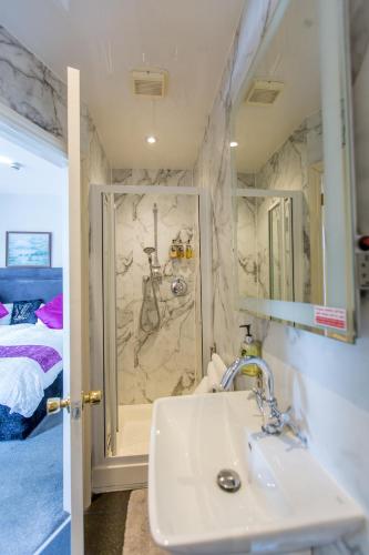 a bathroom with a sink and a shower at Ilkley Riverside Hotel in Ilkley