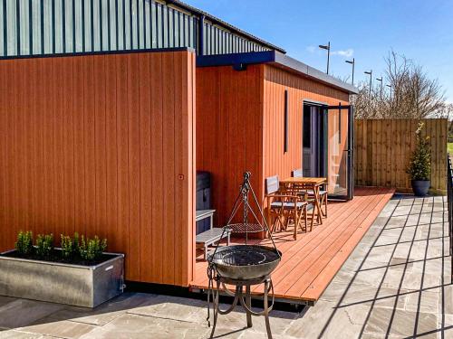 a small house on a deck with a grill at The Pod - Uk38513 in Babcary