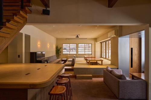 a living room and dining room with a table and chairs at 入山登 in Hakuba