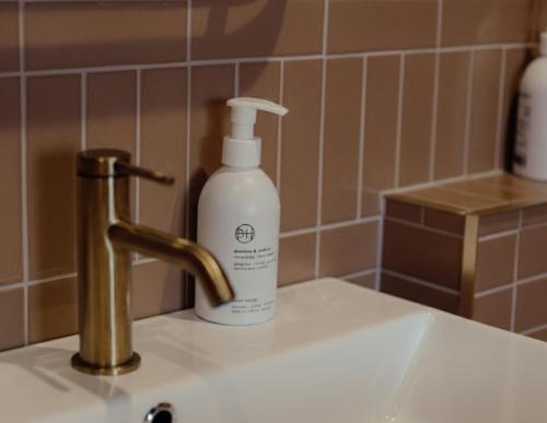 a bottle of soap sitting on top of a sink at Lyzzick in Keswick