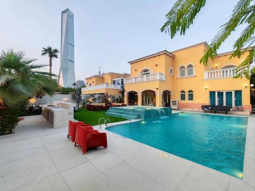 a swimming pool in front of a house at Royal Palazzo with private Pool and BBQ on Marina, huge 7Bedroom Villa in Dubai