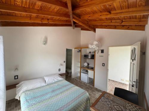a bedroom with a bed and a table and a mirror at Complejo Hueney in Mar de Ajó
