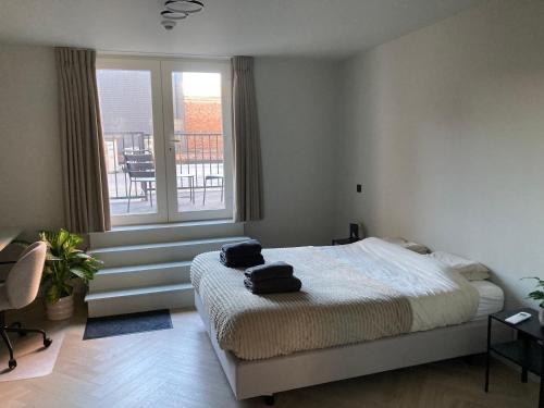 a bedroom with a bed with two bags on it at Allies Avenue in Leuven
