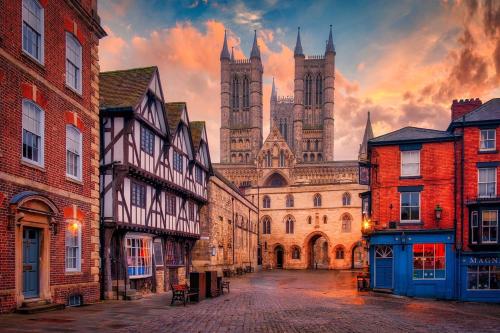 an old street with a castle in the background at 2nd DANESGATE in Lincoln