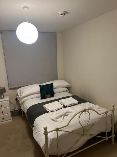 a small bedroom with a bed with a light at 3 Private Rooms in Shared Apartment with Kitchen in Leeds