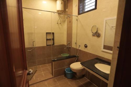 a bathroom with a sink and a toilet and a shower at Hotel Raya's Annexe 1 in Kumbakonam