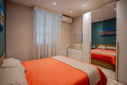 a small bedroom with two beds and a mirror at 9 Studio Flat in Victoria