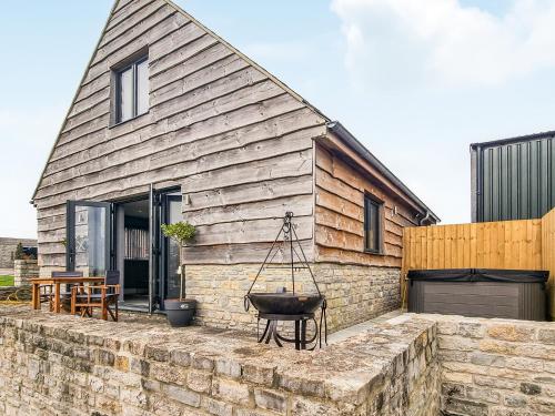 a house with a stone wall in front of it at The Stables - Uk38514 in Babcary