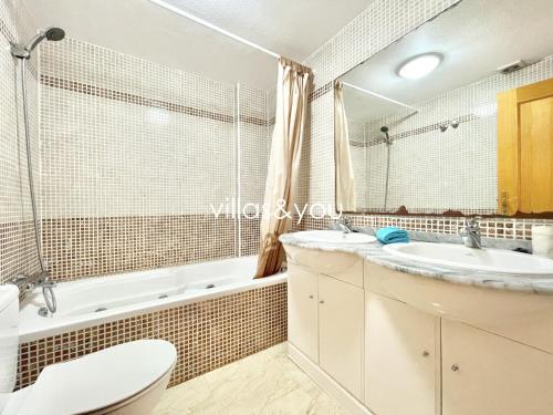 a bathroom with a sink and a tub and a toilet at Amapolas by Villas&You in Orihuela Costa