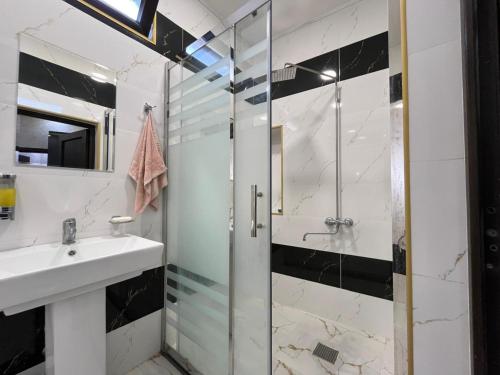 a bathroom with a sink and a shower at Ganja VIP Home in Ganja