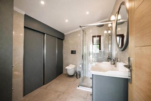 a bathroom with a sink and a shower and a toilet at Villa Miramar Kalkan in Kalkan