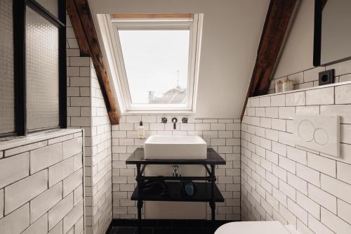 a bathroom with a sink and a window at Adam Downtown in Amsterdam