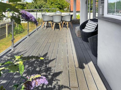 a deck with a table and chairs on a house at Beach Haven in Sheringham