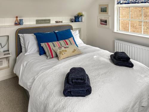 a bedroom with a bed with towels on it at Beach Haven in Sheringham
