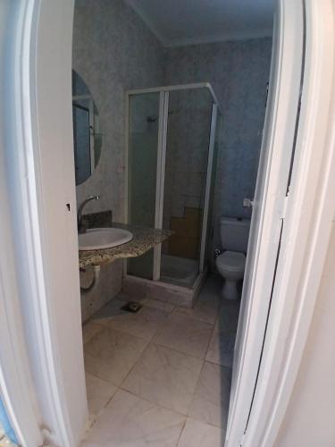 a bathroom with a shower and a sink and a toilet at Regency Hotel Sharm in Sharm El Sheikh