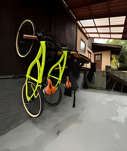 a green bike is hanging on a wall at Beautiful View Villa: Sea and Forest in São Francisco do Sul