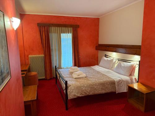 a bedroom with a bed with two towels on it at Driades in Kalavrita