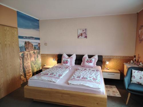 a bedroom with a large bed with pink pillows at Gästehaus Schirner in Niederau
