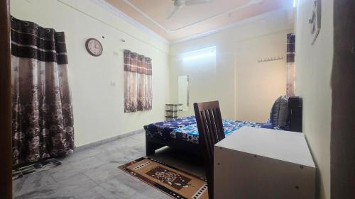 a room with a bed and a clock on the wall at Crystal Mansion in Hyderabad