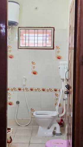 a bathroom with a toilet and a shower at Crystal Mansion in Hyderabad
