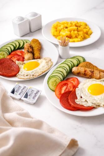 three plates of breakfast food on a table at Woodgrove Cabanas in Negombo