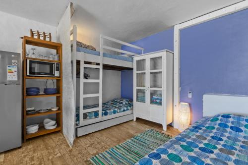 a bedroom with two bunk beds and a microwave at BlueMoon Studio on the Beach! in Trou d'Eau Douce