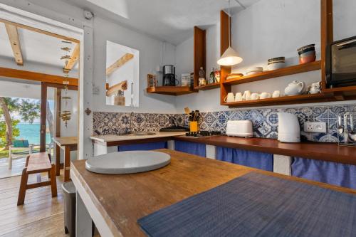 a kitchen with a wooden counter top in a room at BlueMoon Studio on the Beach! in Trou d'Eau Douce