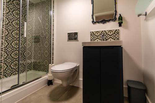 a bathroom with a toilet and a shower at The Music Rooms in Bewdley