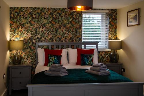 a bedroom with a bed with towels on it at The Music Rooms in Bewdley