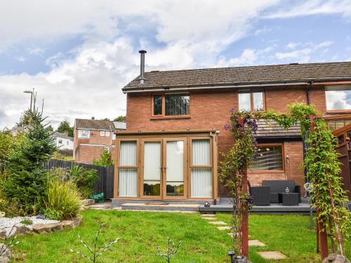 a brick house with large windows and a yard at Zebra House in Blaenavon