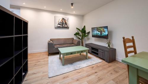 a living room with a couch and a table at The Suite - Eindhoven - By T&S in Eindhoven