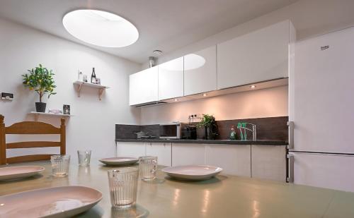a kitchen with a table with plates on it at The Suite - Eindhoven - By T&S in Eindhoven