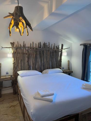 a bedroom with a large bed with towels on it at Manade des Baumelles in Saintes-Maries-de-la-Mer