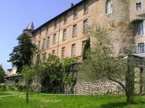 a large brick building with trees in front of it at Appartement 3 étoiles - eecfga in Saint-Lizier