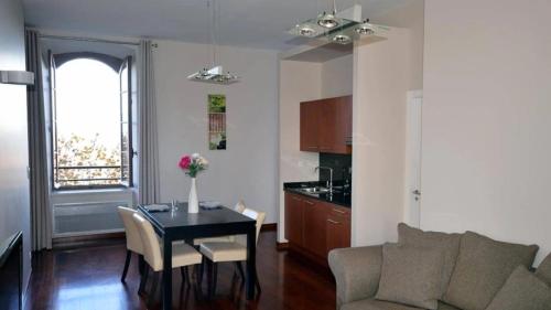 a living room with a table and a kitchen at Appartement 3 étoiles - eecfga in Saint-Lizier
