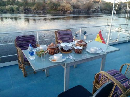 a table on the deck of a boat on the water at Nile Dream Yacht in Jazīrat Salūjah
