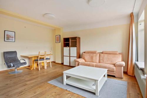 a living room with a couch and a table at Eindhoven City Center Apartment in Eindhoven