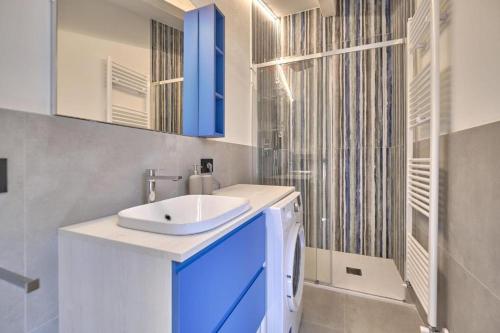 a bathroom with a sink and a shower at Hotel Cortina in Garda