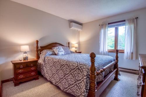 a bedroom with a bed and a window at On River Time Bring Your Pup Pool in Bartlett