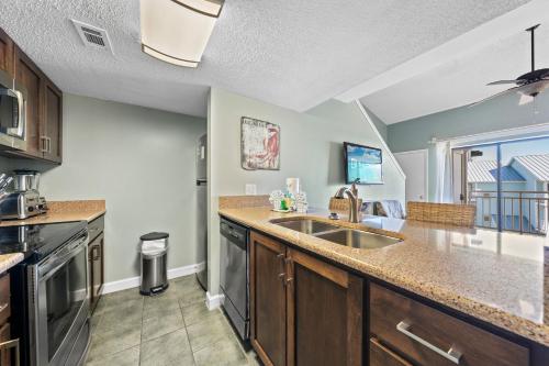 a kitchen with a sink and a counter at Sugar Beach 313 in Gulf Shores
