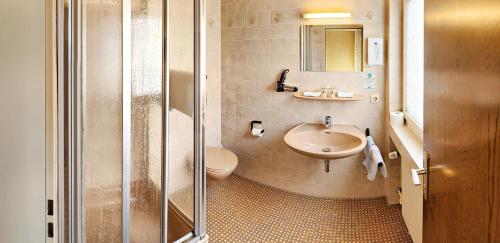 a bathroom with a sink and a toilet at Hotel Keinath Stuttgart in Stuttgart