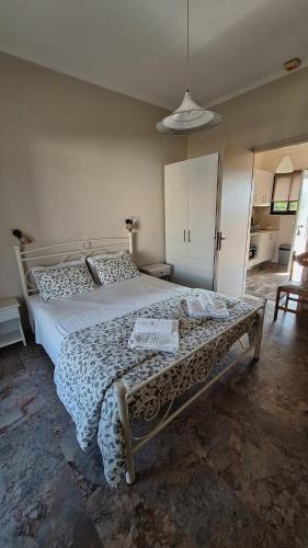 a bedroom with a large bed in a room at Antzela Apartments in Sidari