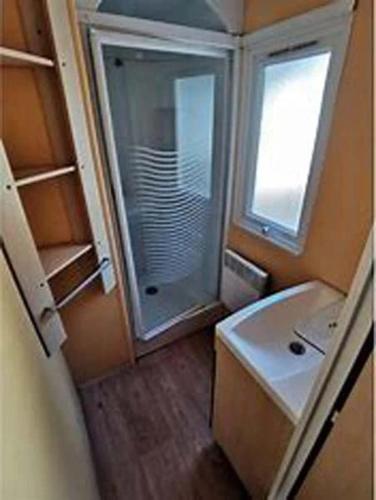 a small bathroom with a sink and a shower at ZEcamping 4 étoiles piscine couverte piscine chauffée locatif 4 pers in Wavans