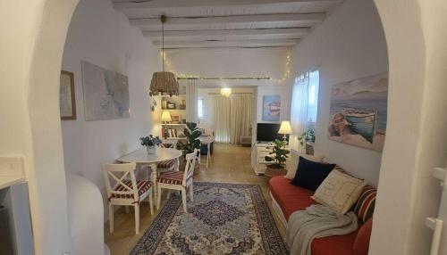 a living room with a couch and a table at Stunning Sea-View Villa w Access to Shared Pools in Mikonos