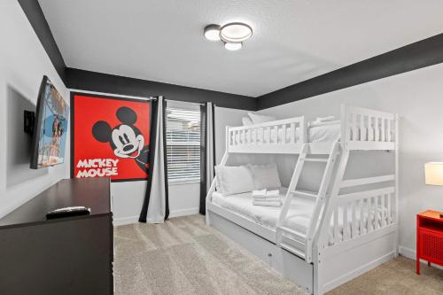 a bedroom with two bunk beds and a ladder at Special 4bedroom TH w-private pool next to Disney in Kissimmee