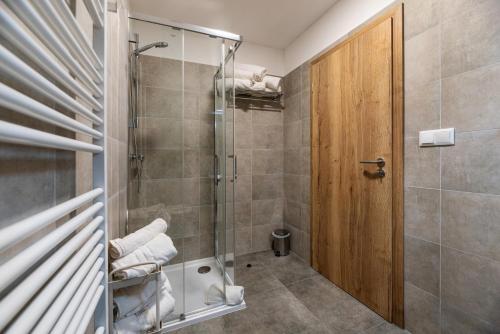 a bathroom with a shower with a glass door at Apartmány Dalešice in Dalešice