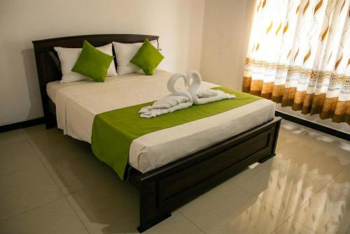 a bedroom with two swans towels on a bed at The Nature in Tangalle